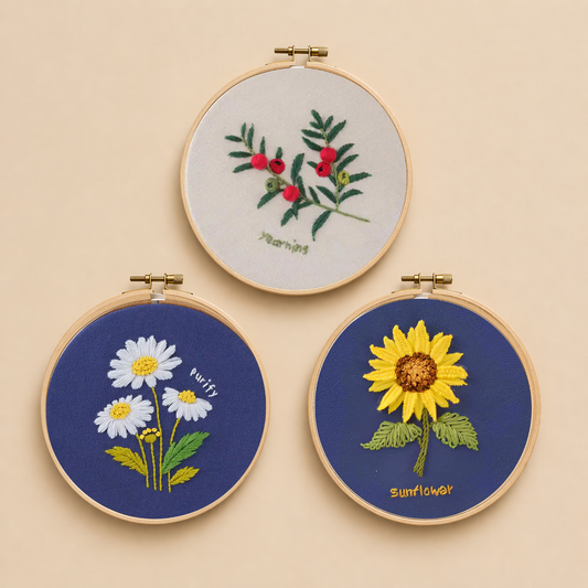 Three hoops with three floral designs of daisies, a sunflower and berries