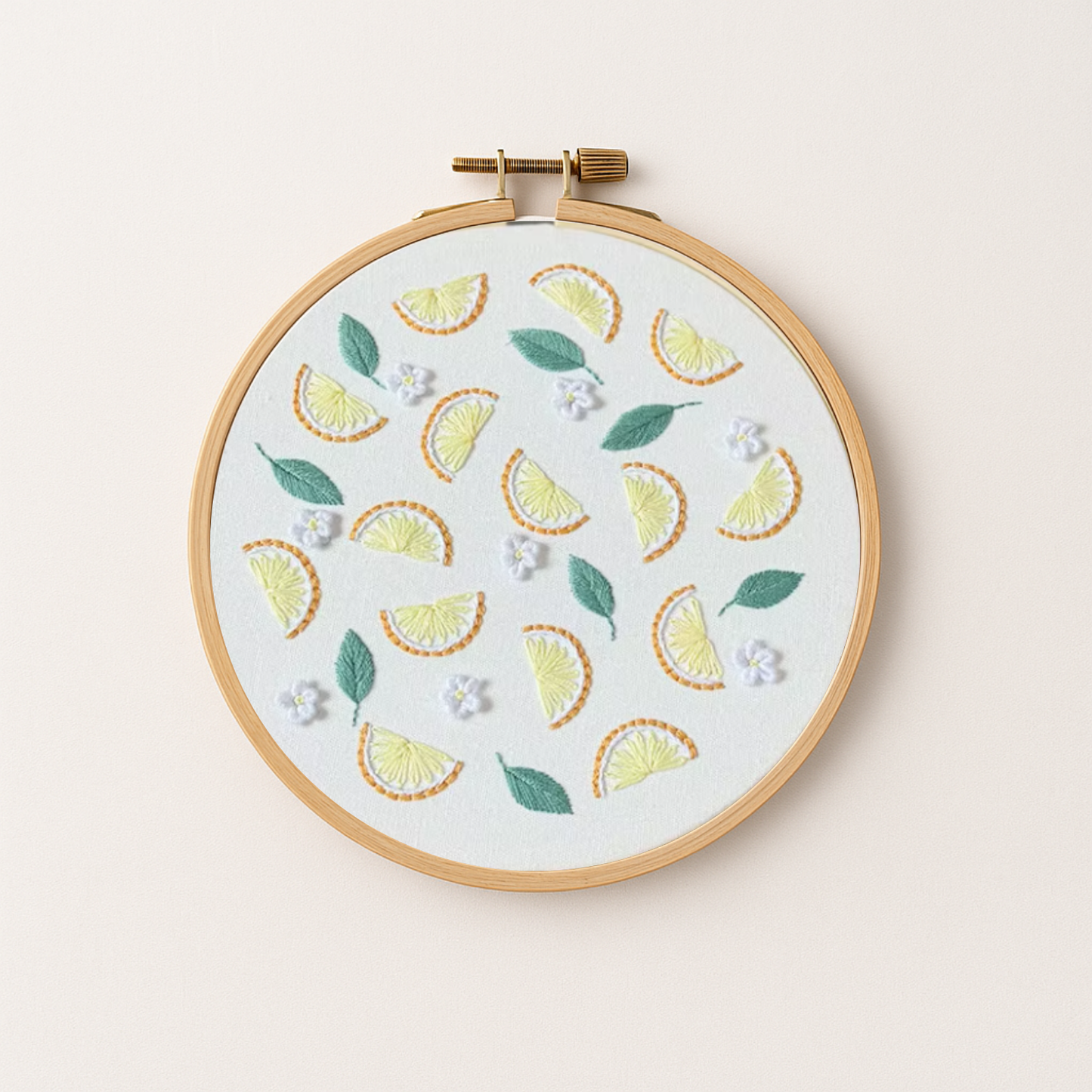 An embroidery hoop with a lemon embroidery design