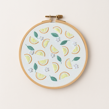An embroidery hoop with a lemon embroidery design
