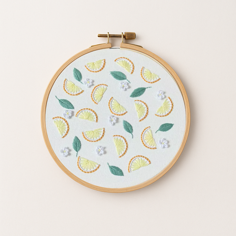 An embroidery hoop with a lemon embroidery design