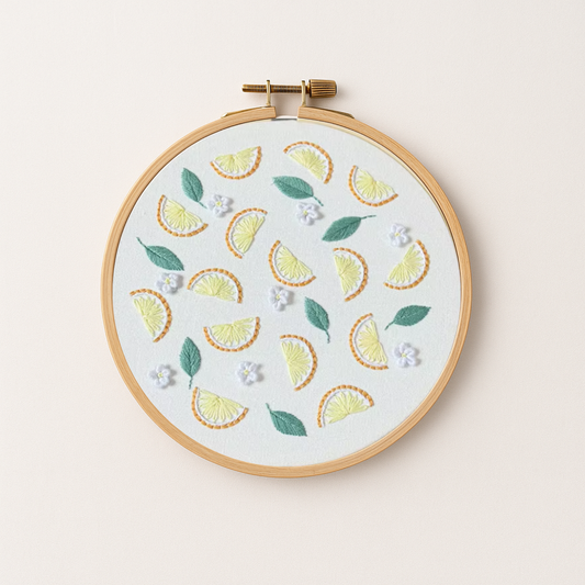 An embroidery hoop with a lemon embroidery design