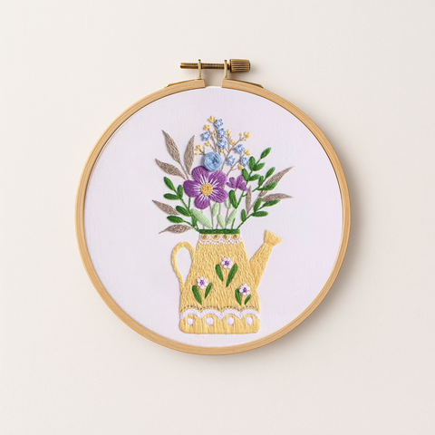 Embroidery hoop with an embroidery design of flowers in a vase